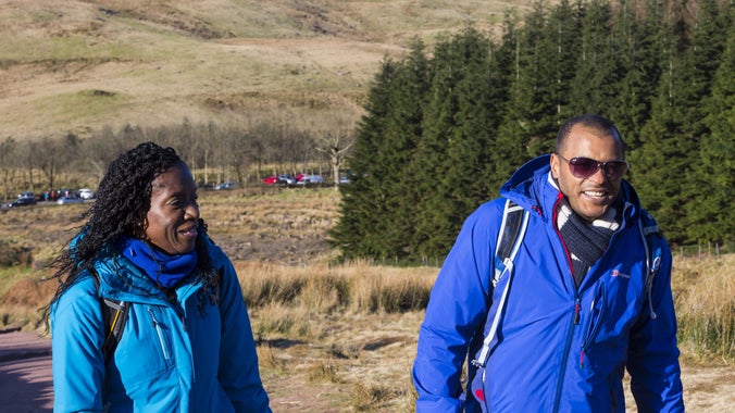 Walkers exploring the Beacons Way path between Pont ar Daf and Pen y Fan in the Brecon Beacons National Park, Wales